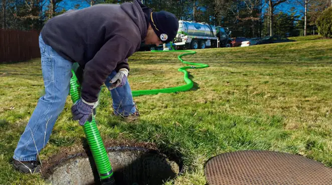 Service technician performing residential septic pumping and drainage maintenance in Tacoma, WA